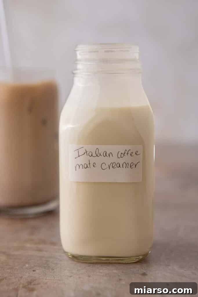 Homemade Coffee Mate Italian Sweet Cream in a glass bottle, ready to be poured into coffee.