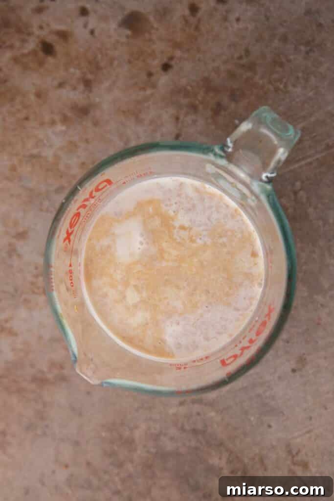 Half and half poured into a clear measuring cup.