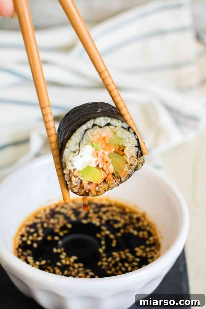 Close-up of freshly rolled quinoa sushi with colorful vegetables inside.