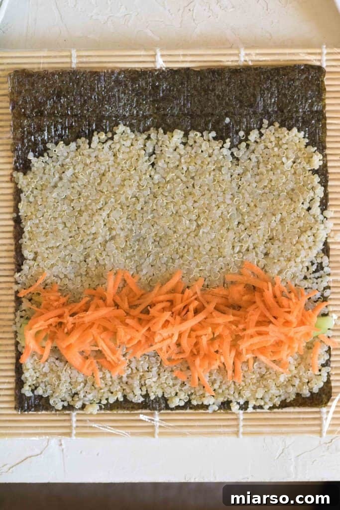 Adding carrots to the quinoa sushi roll.