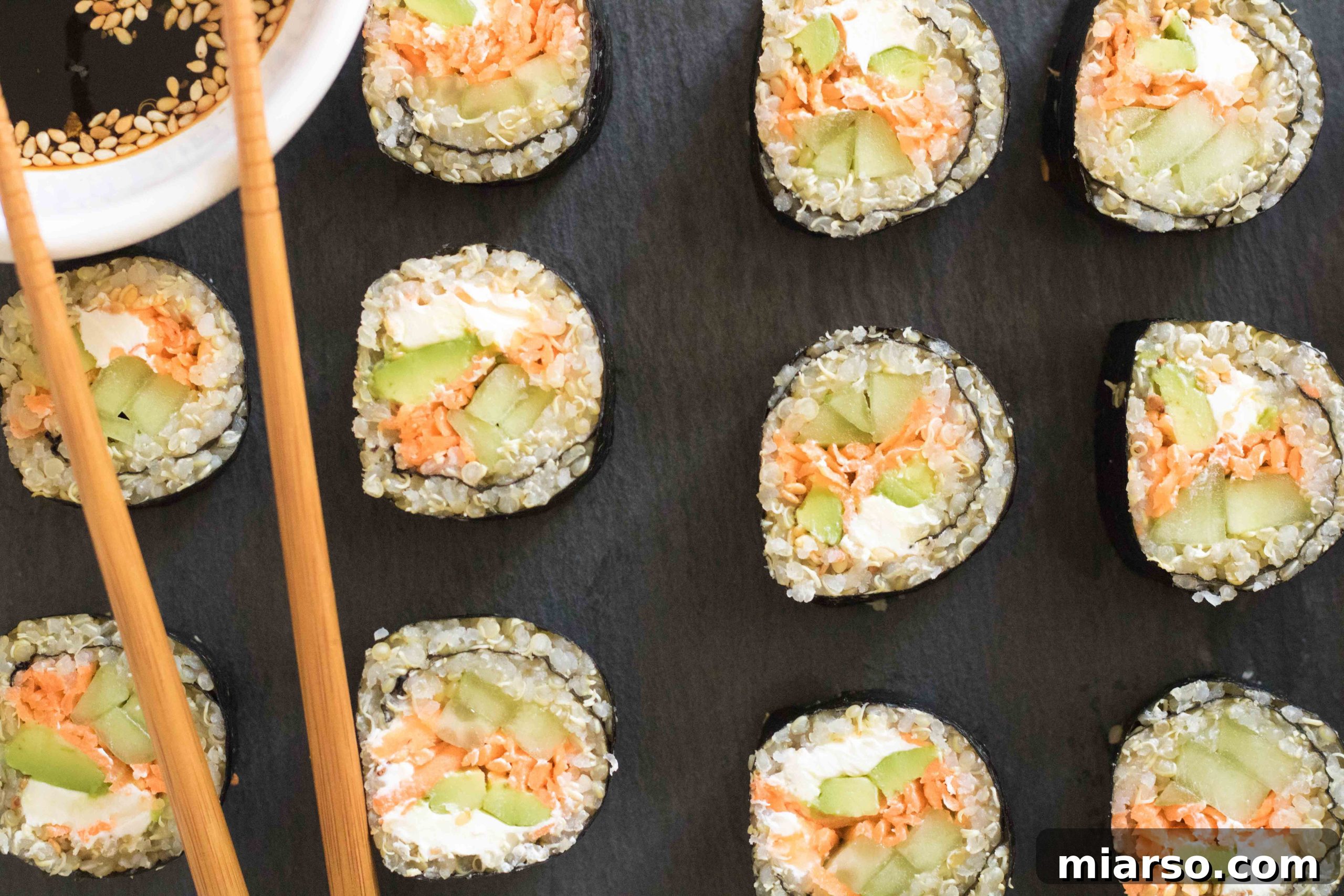 Colorful vegetable quinoa sushi rolls arranged on a plate, ready to serve.
