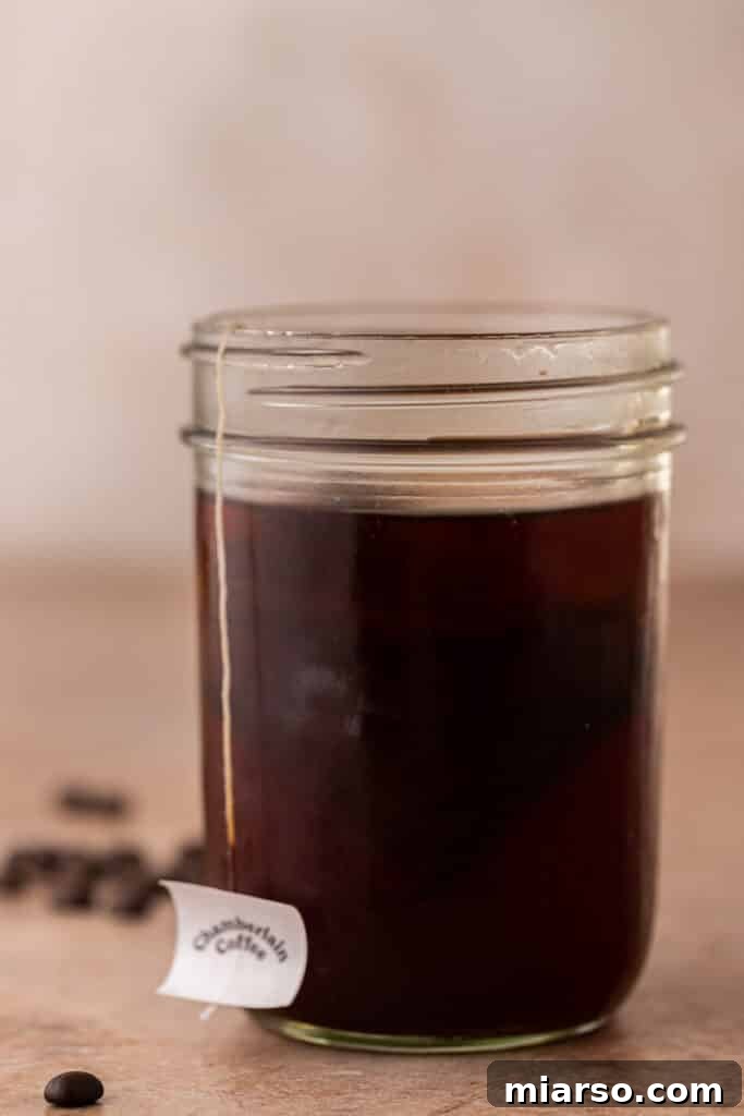 Cold brew coffee steeping in a mason jar, illustrating the first step of the Emma Chamberlain coffee recipe.