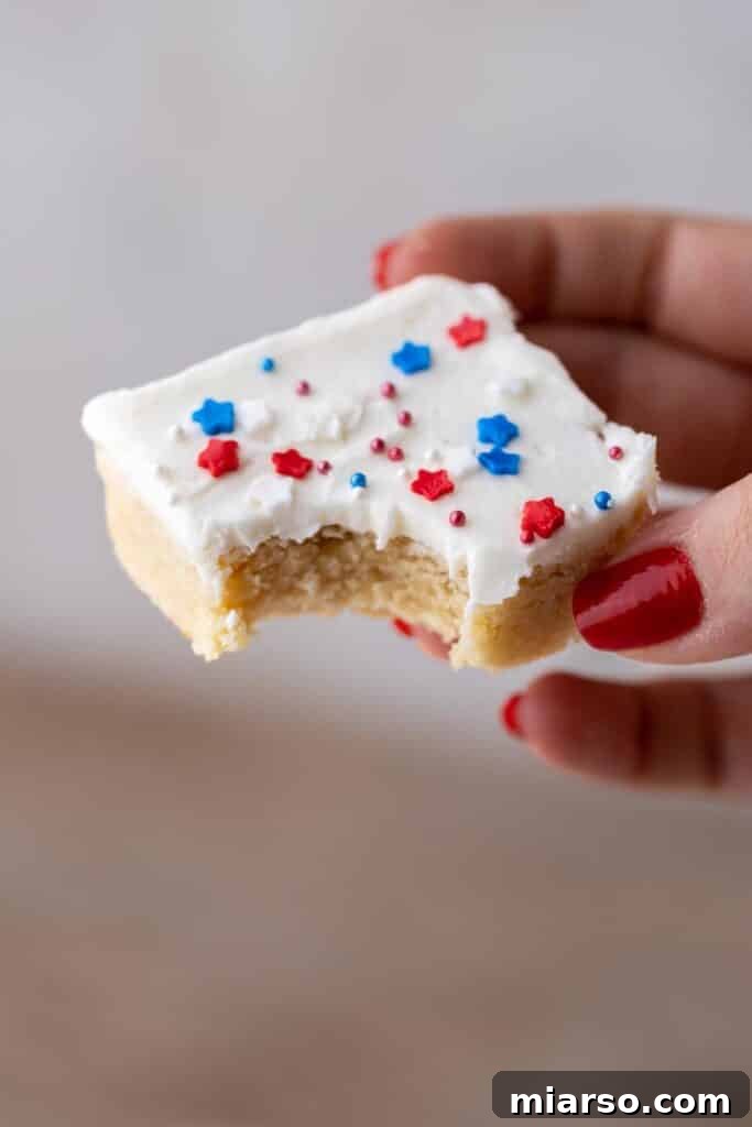 Star-Spangled Sugar Cookie Bars 2 Hand holding patriotic sugar cookies