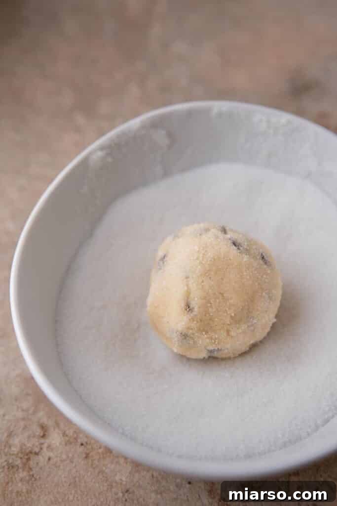 Cookie dough ball rolled in granulated sugar for a sparkling finish.