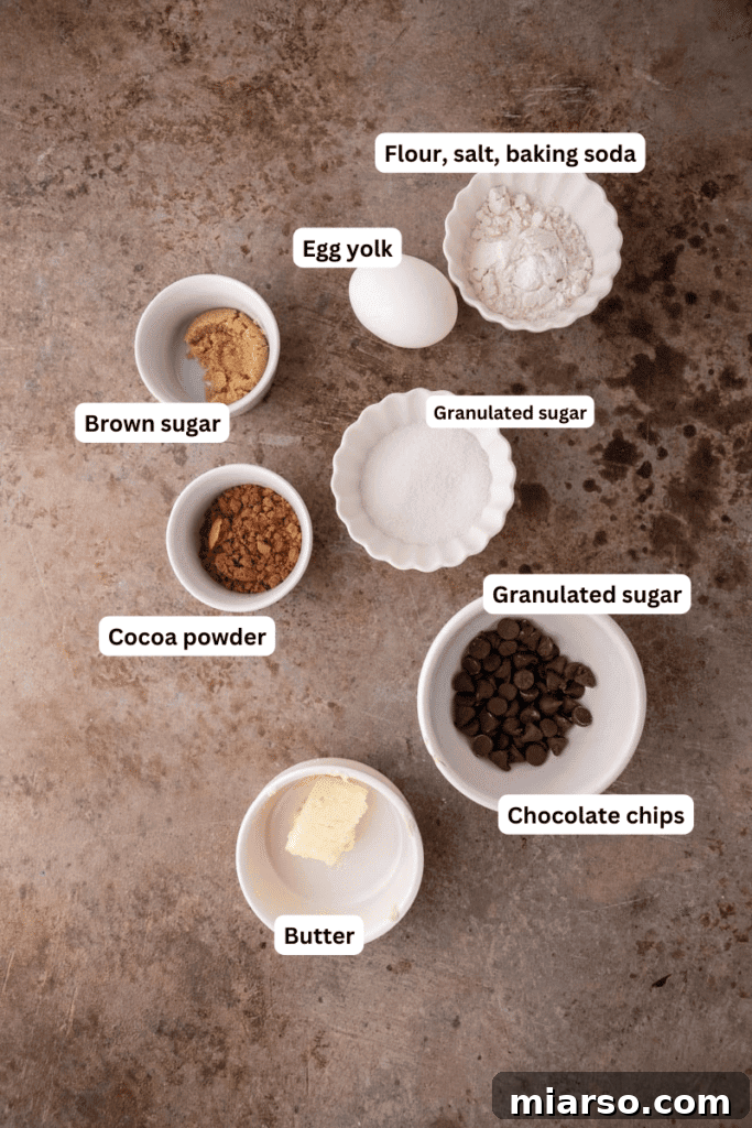 Essential ingredients for baking single serve double chocolate cookie displayed neatly on a kitchen counter.