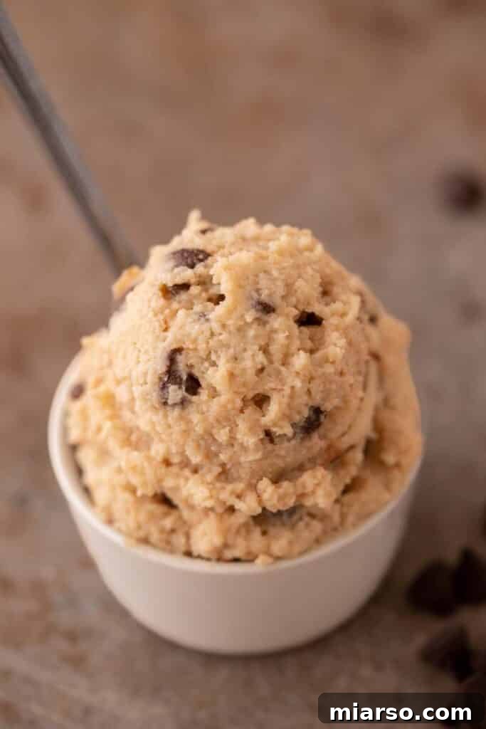 Cottage cheese edible cookie dough served in a bowl with a spoon, ready to eat.