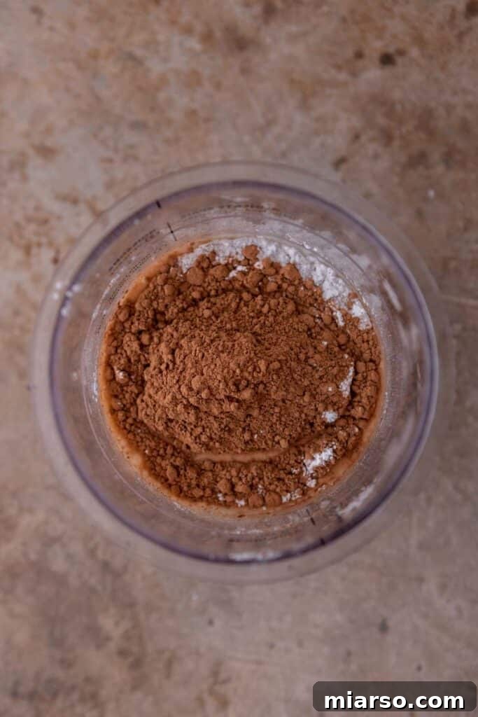 Decadent Ninja Creami Chocolate Ice Cream 4 Ingredients being added to a Ninja Creami pint cup