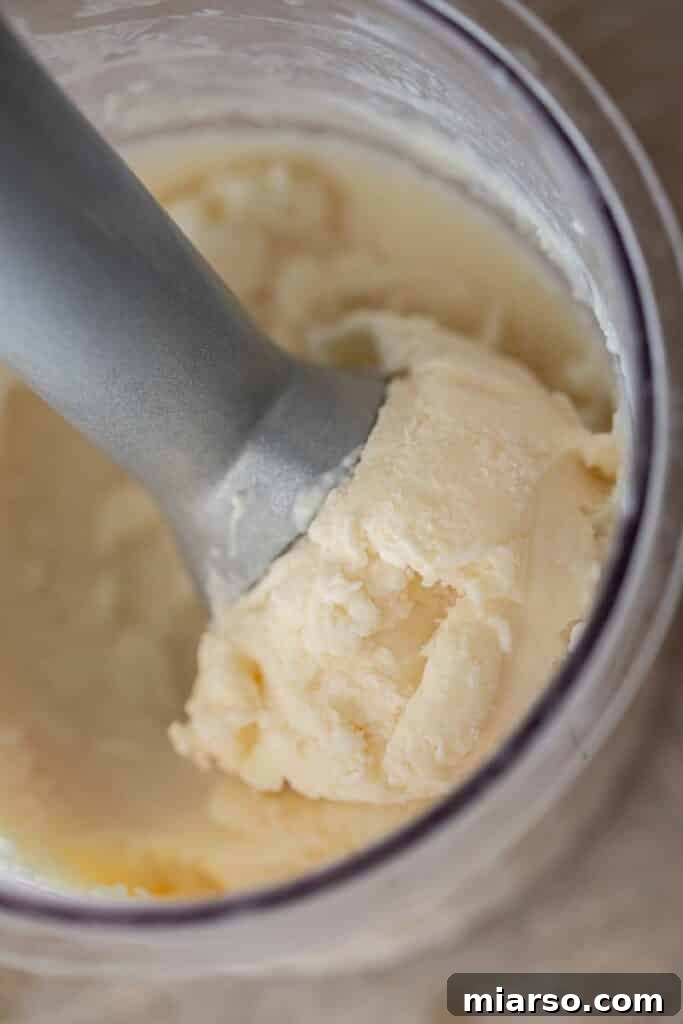 Scooping vanilla ice cream from the Ninja Creami pint 