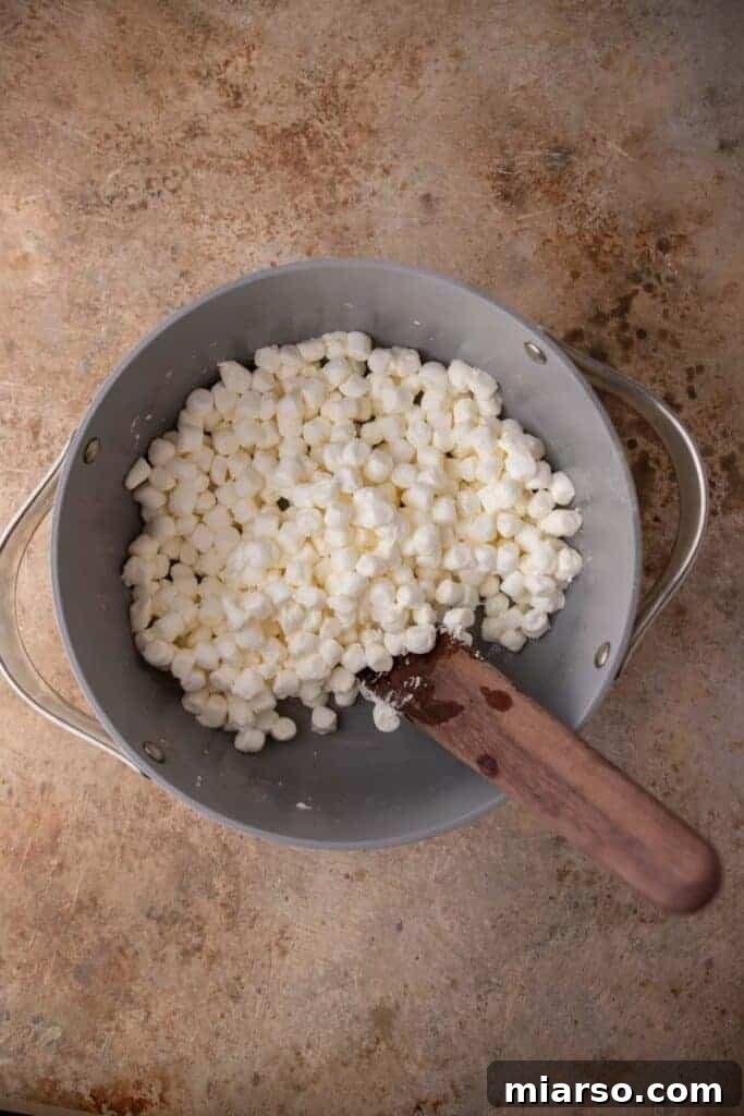 Melted butter with marshmallow in pan, beginning to combine
