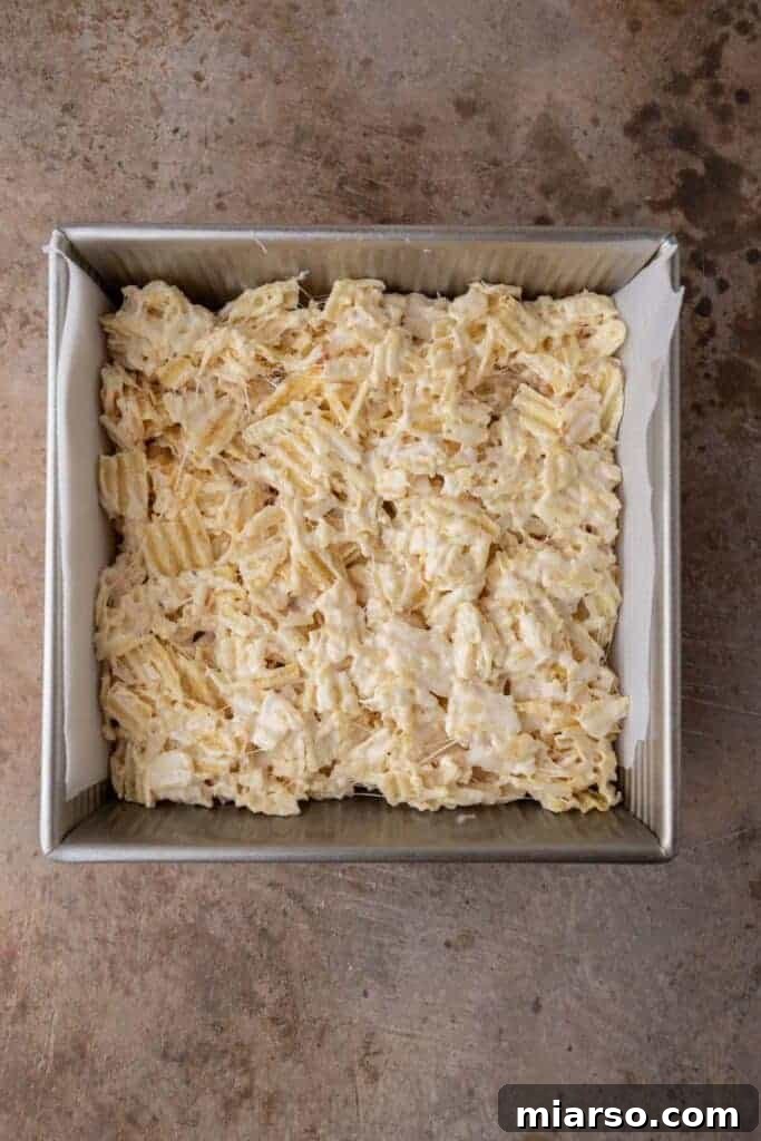 Freshly mixed Ruffles marshmallow treats in a baking pan