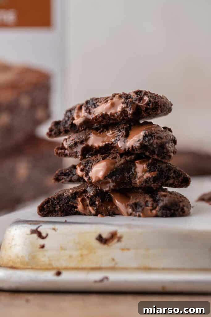 Your New Favorite Brownie Mix Cookies 2 Close-up of freshly baked brownie mix cookies, showcasing their fudgy texture and shiny, cracked tops.