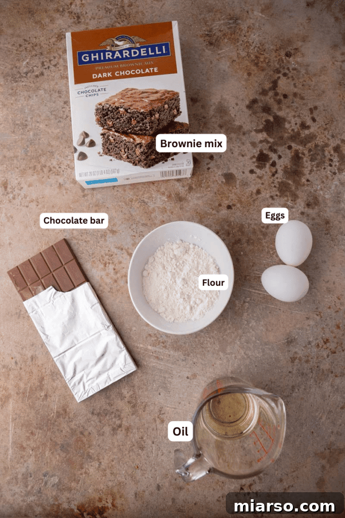 Your New Favorite Brownie Mix Cookies 3 A collection of ingredients neatly laid out on a kitchen counter, including a brownie mix box, flour, eggs, and oil.