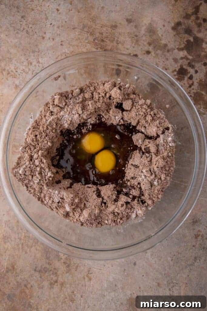 Your New Favorite Brownie Mix Cookies 5 Wet ingredients in a mixing bowl before combining with dry ingredients for brownie mix cookies.