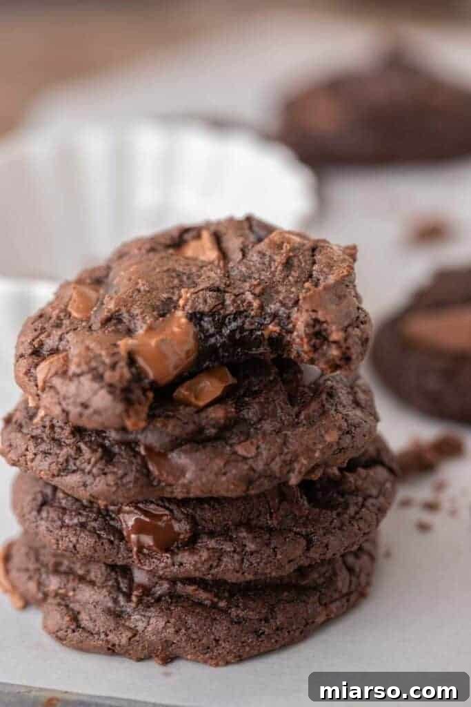 Your New Favorite Brownie Mix Cookies 9 A stack of fudgy brownie mix cookies, showing off their thickness and inviting texture.
