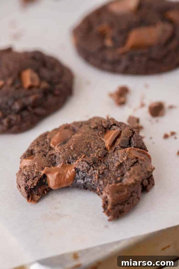 Your New Favorite Brownie Mix Cookies 10 A brownie mix cookie with a bite taken out of it, revealing its soft, fudgy interior.