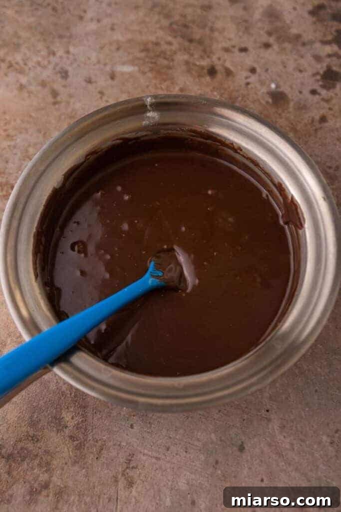 Decadent Starbucks Oat Fudge Bars 9 Chocolate fudge melting in a saucepan.