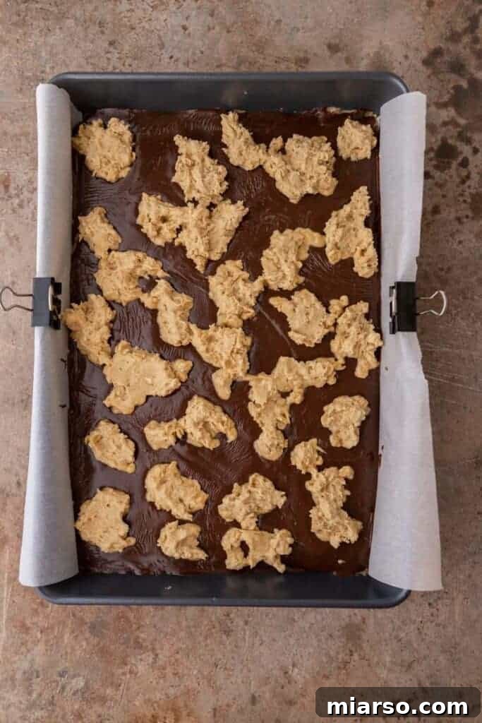 Decadent Starbucks Oat Fudge Bars 10 Oat fudge bars before baking, showing the fudge layer and crumb topping.