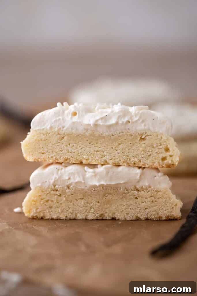 A perfectly baked Crumbl vanilla cookie sliced in half, revealing its thick, soft interior.