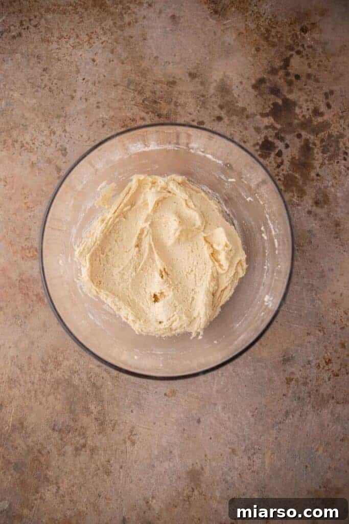 Cookie dough in a bowl, perfectly mixed and ready for scooping.