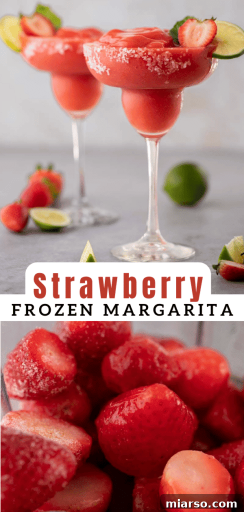 Close-up of a frozen strawberry margarita in a glass, with a strawberry garnish.