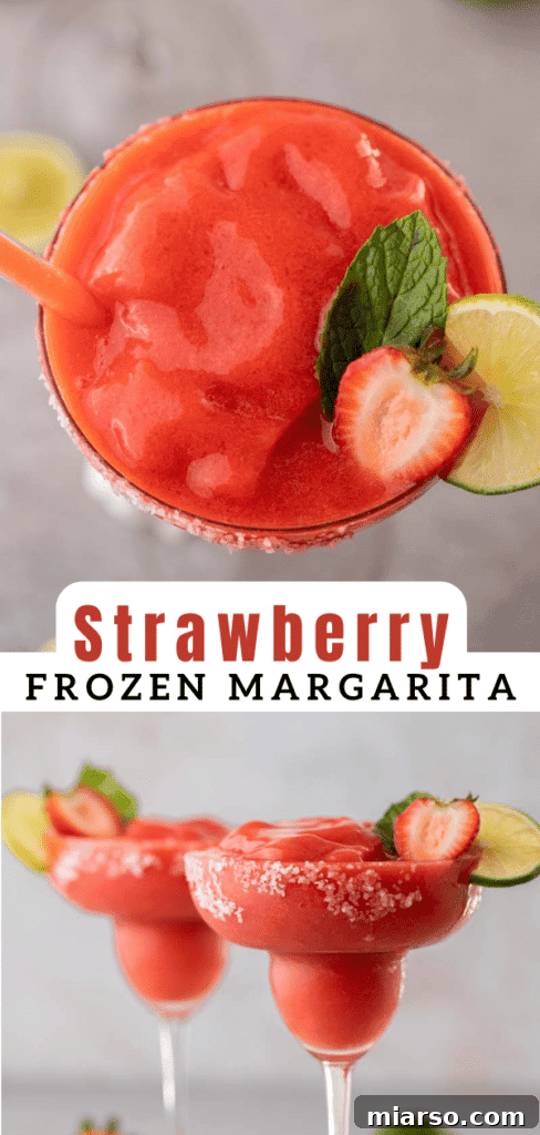 Frozen strawberry margarita with a lime wedge and strawberry slice as garnish.
