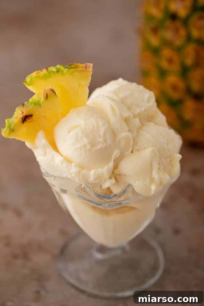 Creamy Ninja Creami pineapple sorbet in a glass, ready to be enjoyed.