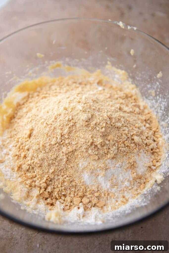 A bowl containing dry ingredients like flour, baking soda, and salt, ready to be mixed.