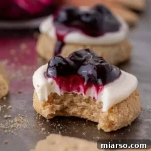 A delicious Crumbl blueberry cheesecake cookie with a bite taken out of it