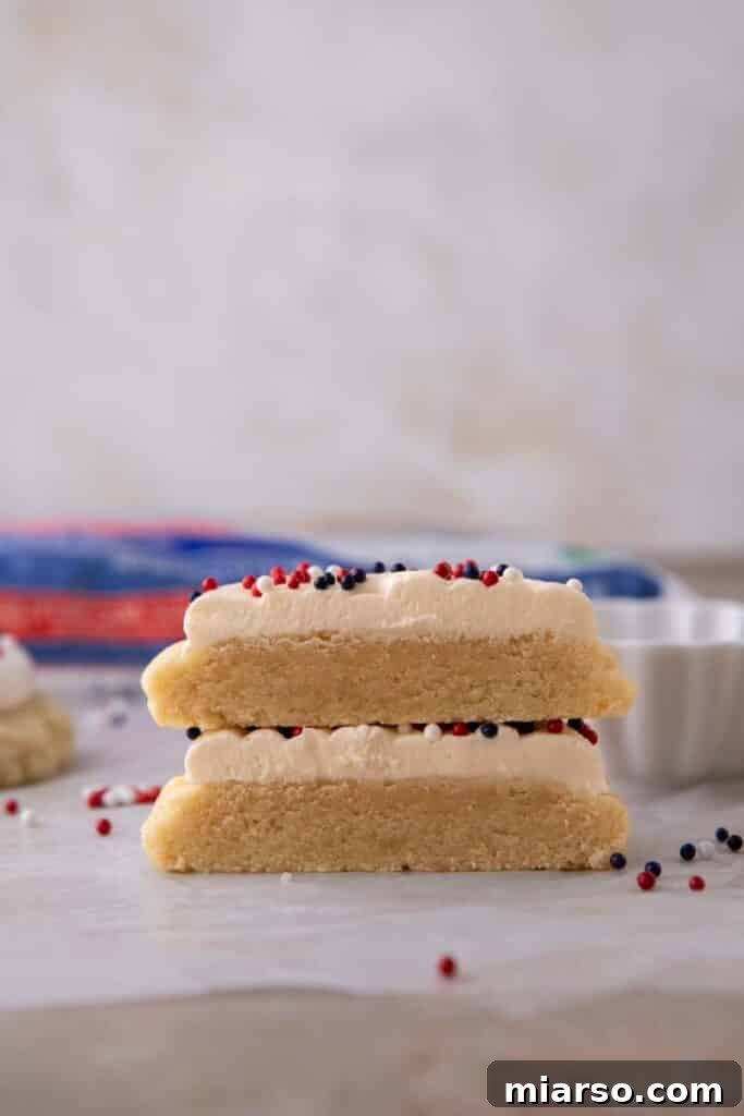 Stack of Crumbl patriotic cookies with frosting and sprinkles