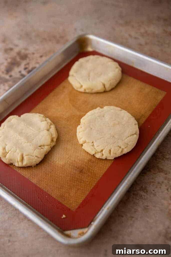 Baked sugar cookies cooling in a baking pan