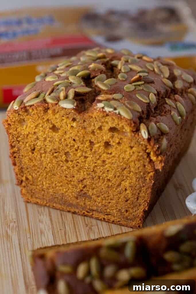 A delicious slice of Starbucks pumpkin bread copycat, cut in half to show its moist interior.
