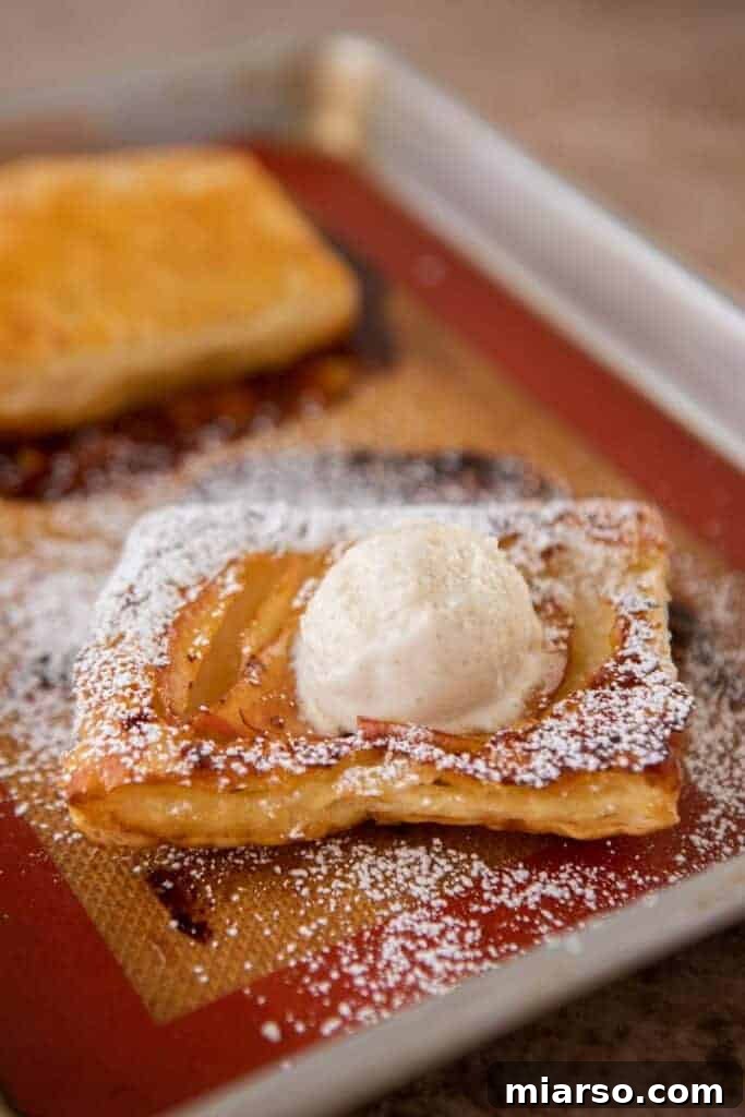 Upside down pastries served with a scoop of vanilla ice cream and caramel sauce