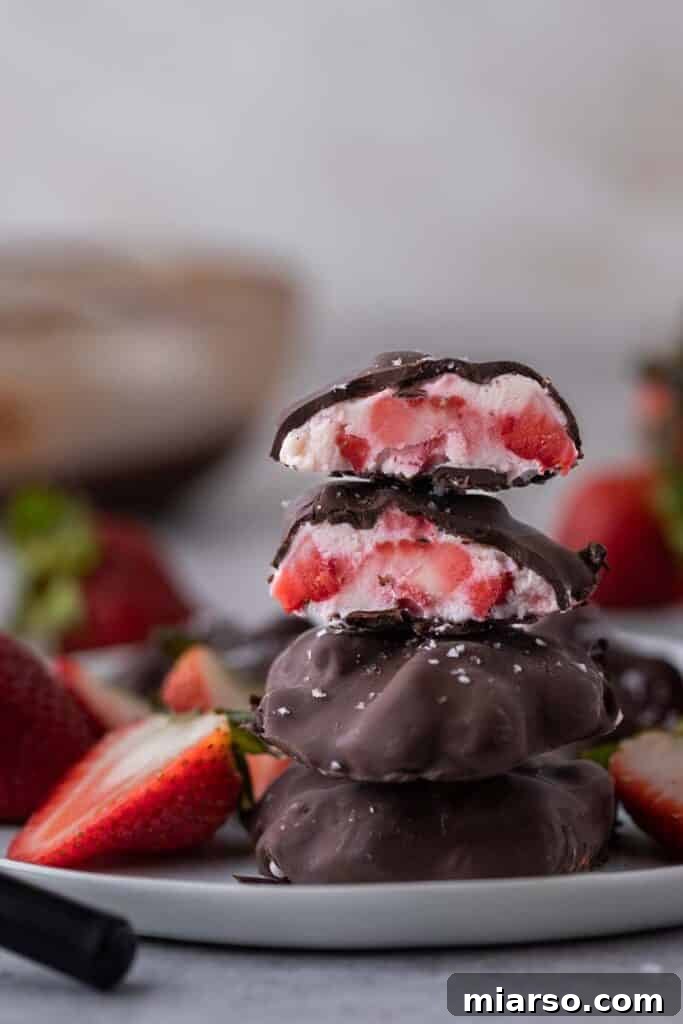 A stack of perfectly frozen Viral Chocolate Strawberry Yogurt Clusters, ready to eat.