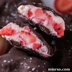 Viral chocolate strawberry yogurt clusters sliced in half, showing creamy interior and chocolate shell.