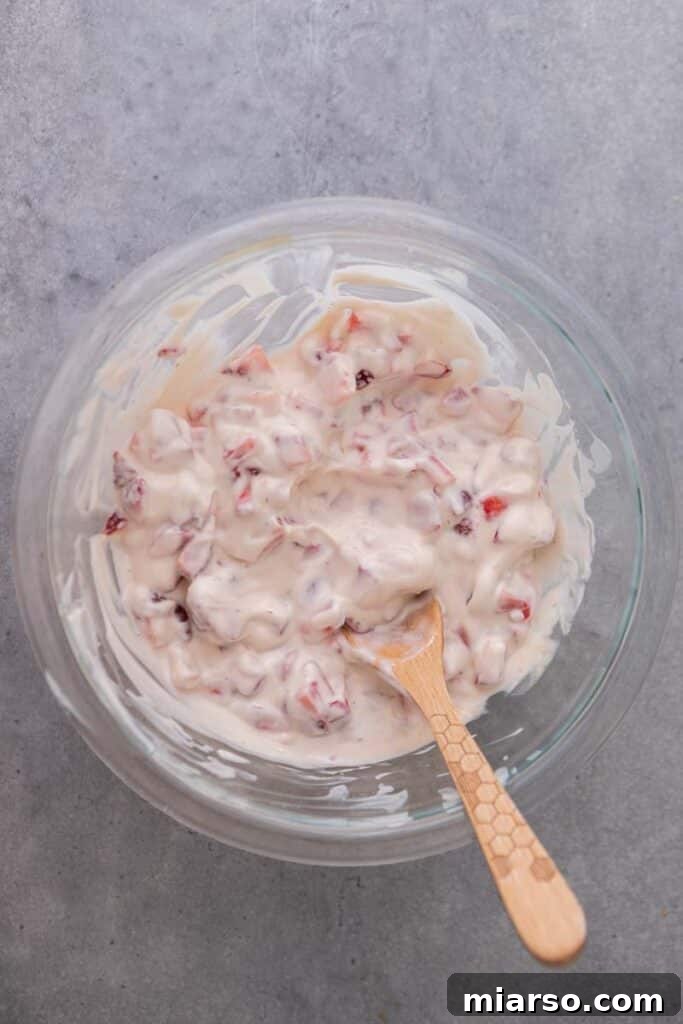 Strawberry yogurt mixture in a bowl after combining all ingredients.