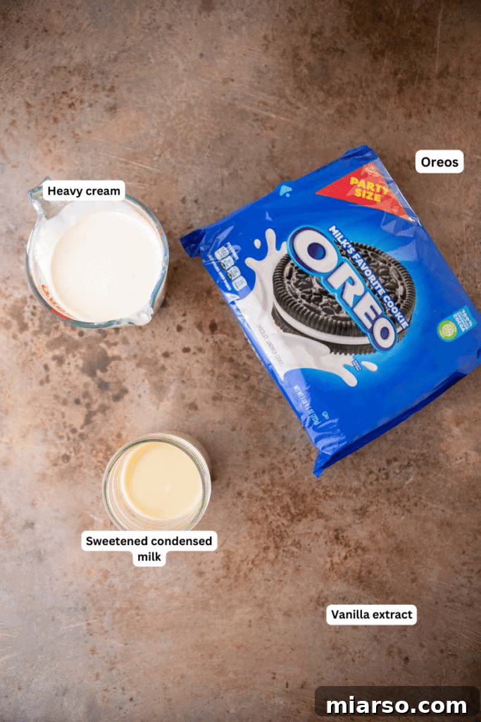 Simply Delicious No Churn Oreo Ice Cream 3 Essential ingredients for no-churn cookies and cream ice cream laid out on a kitchen counter: heavy cream, sweetened condensed milk, vanilla extract, and a pack of Oreo cookies.