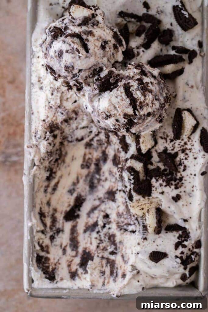 Simply Delicious No Churn Oreo Ice Cream 9 A beautifully presented scoop of frozen no-churn cookies and cream ice cream, showing its smooth texture and visible Oreo chunks.