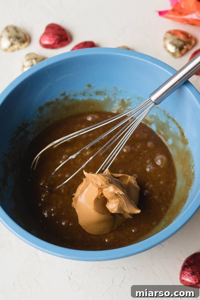 Mixing butter and brown sugar for peanut butter blondies.