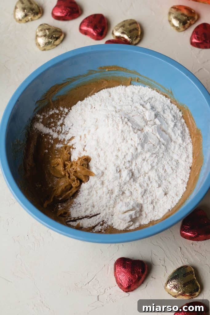 Combining flour and salt into the peanut butter blondie batter.