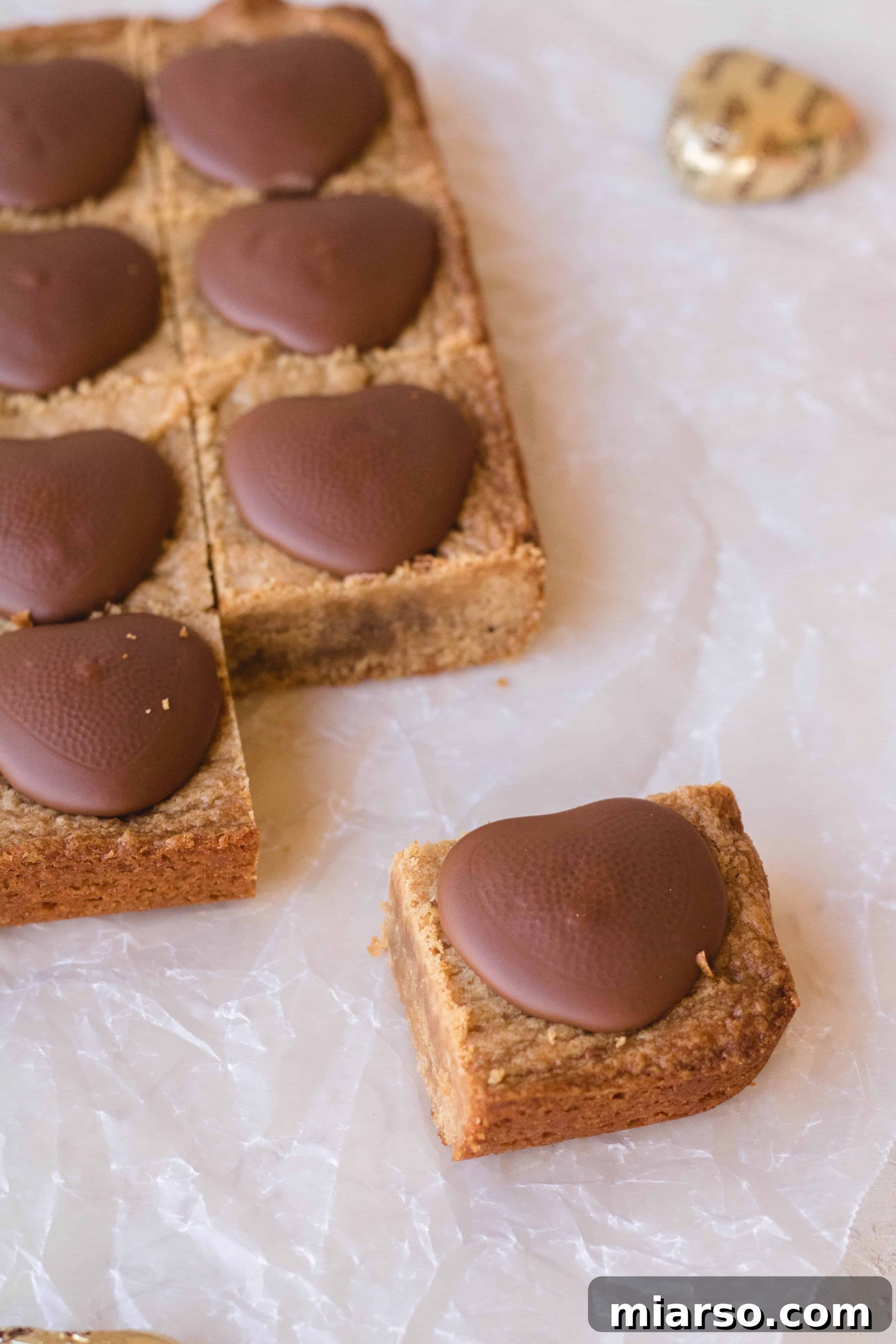 Delicious peanut butter blondies with festive Reese's hearts for a special occasion.