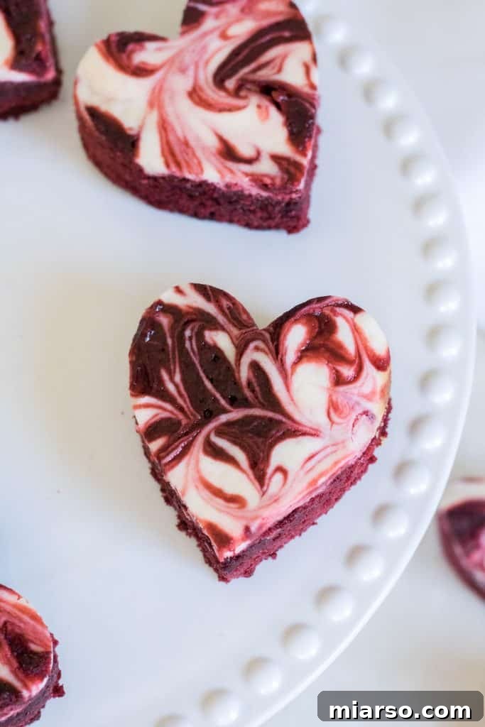 Rich cheesecake swirled red velvet brownies, showing the marbled effect.