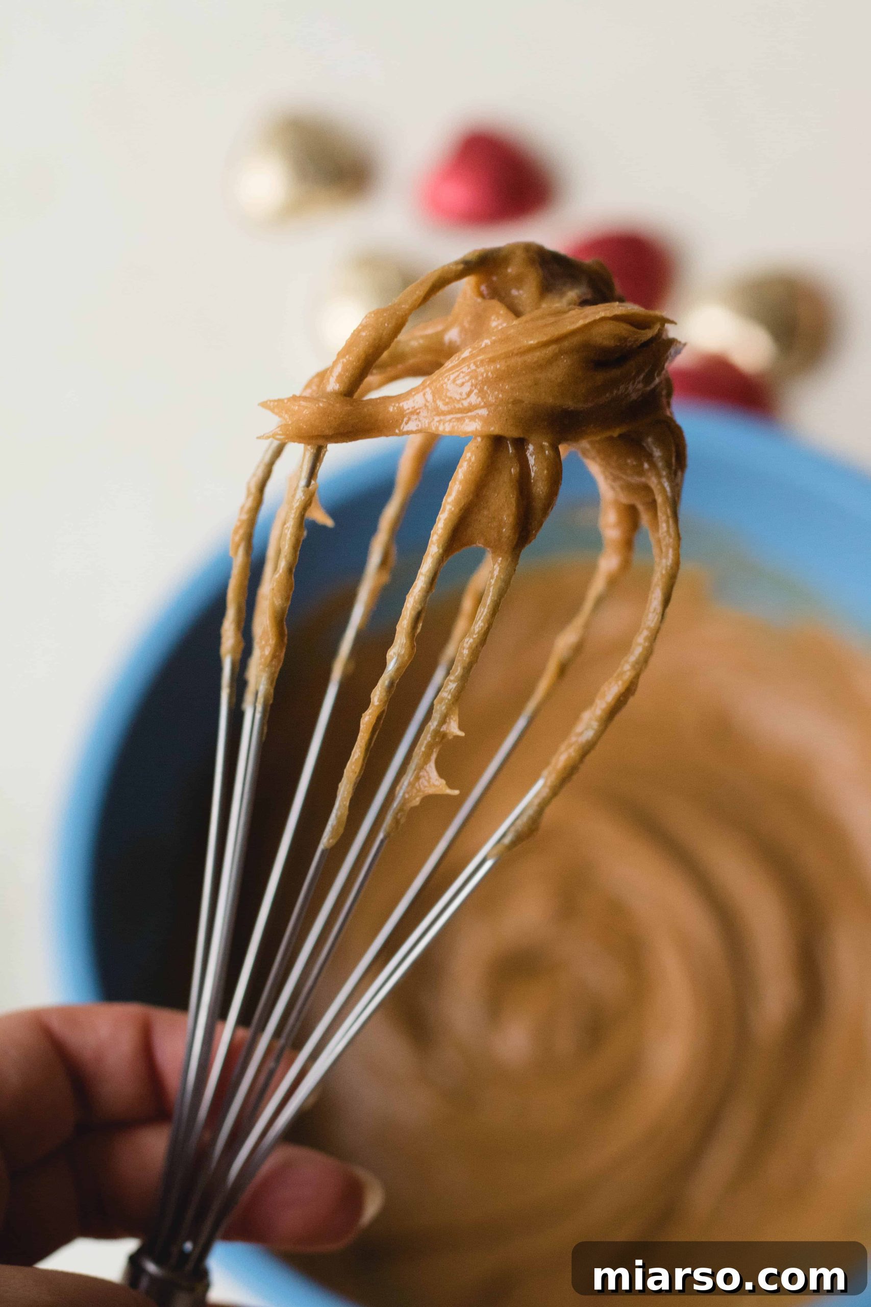 Thick, creamy peanut butter blondies batter in a mixing bowl.