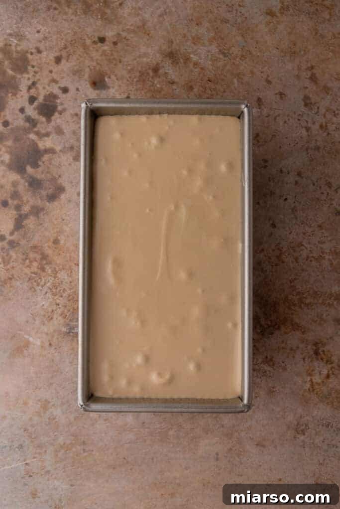 The fully combined coffee ice cream mixture, smooth and ready for freezing in a loaf pan.