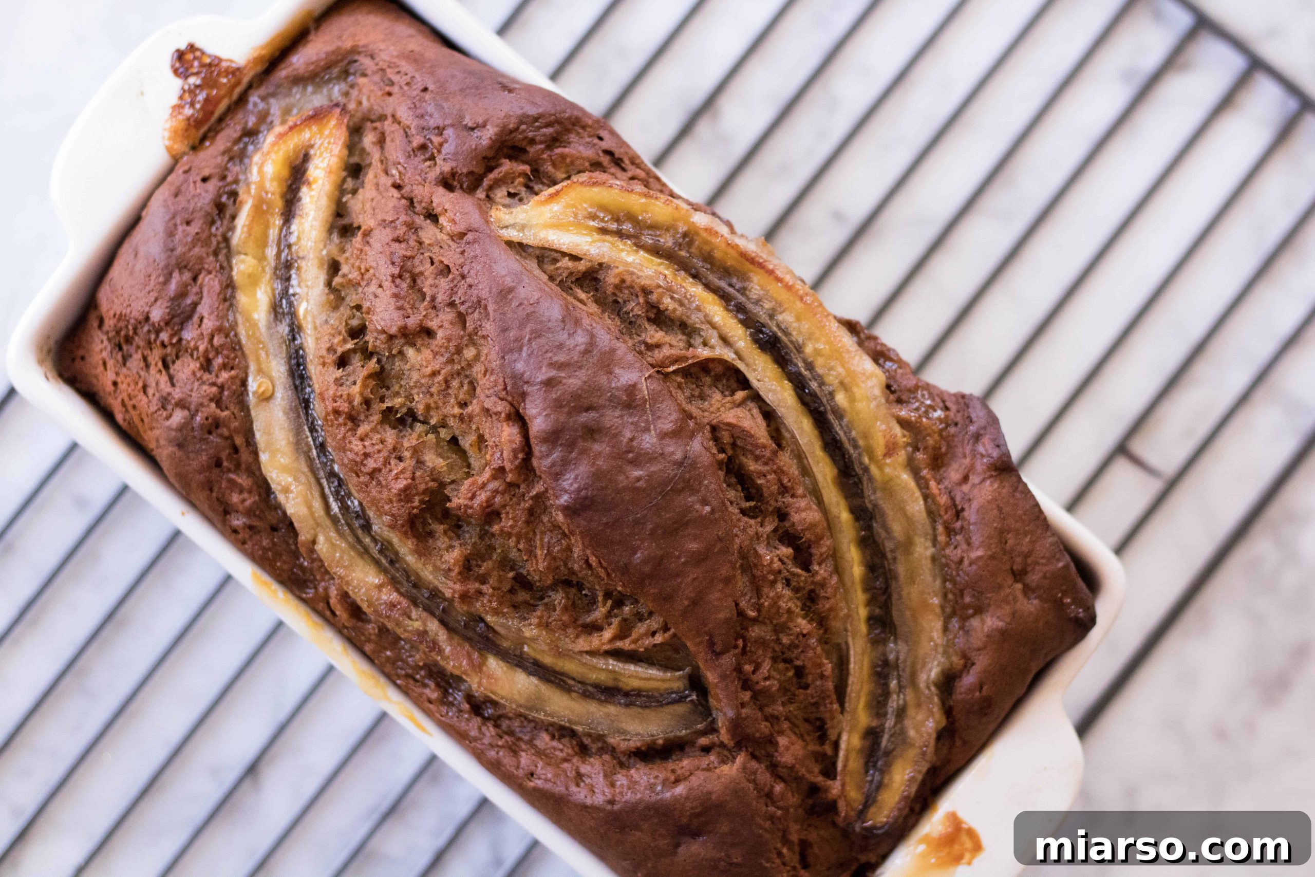 Two loaves of healthy no sugar added banana bread, one whole and one sliced