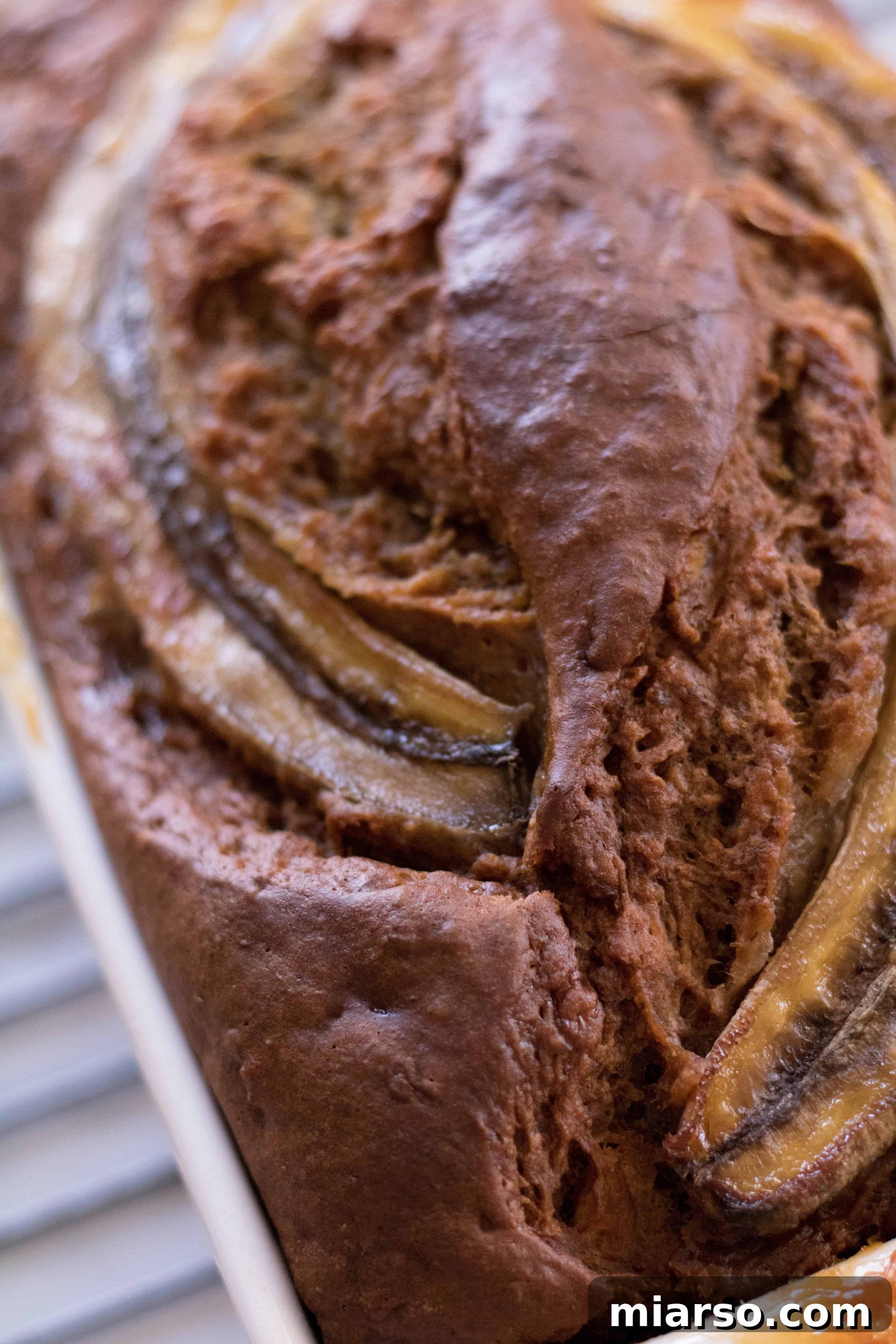 A slice of no sugar added banana bread with a bite taken out, showing its moist texture