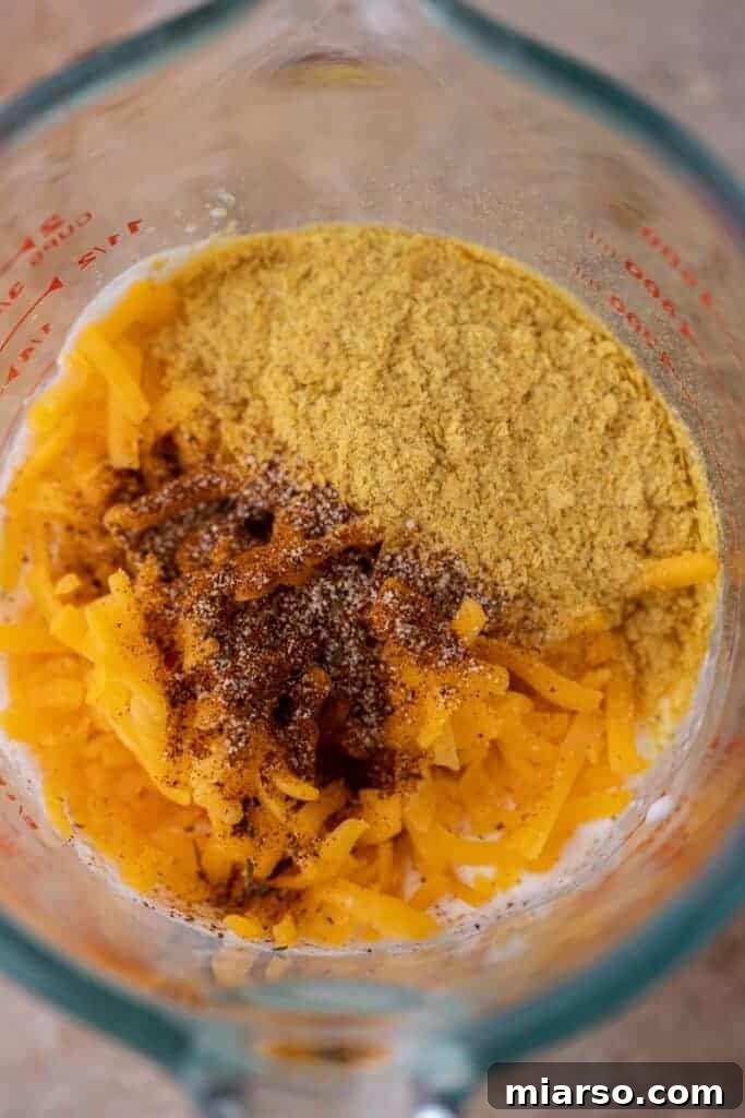 Ingredients for cottage cheese queso inside a blender