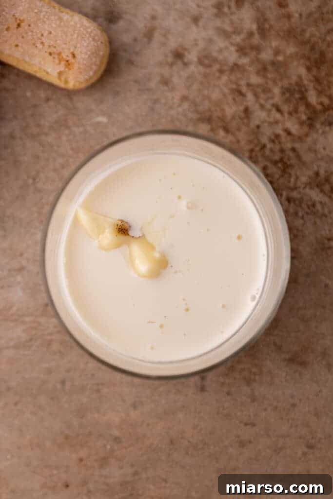 Mastering the Dreamy Tiramisu Latte Recipe 7 Ingredients for tiramisu cold foam in a measuring cup.