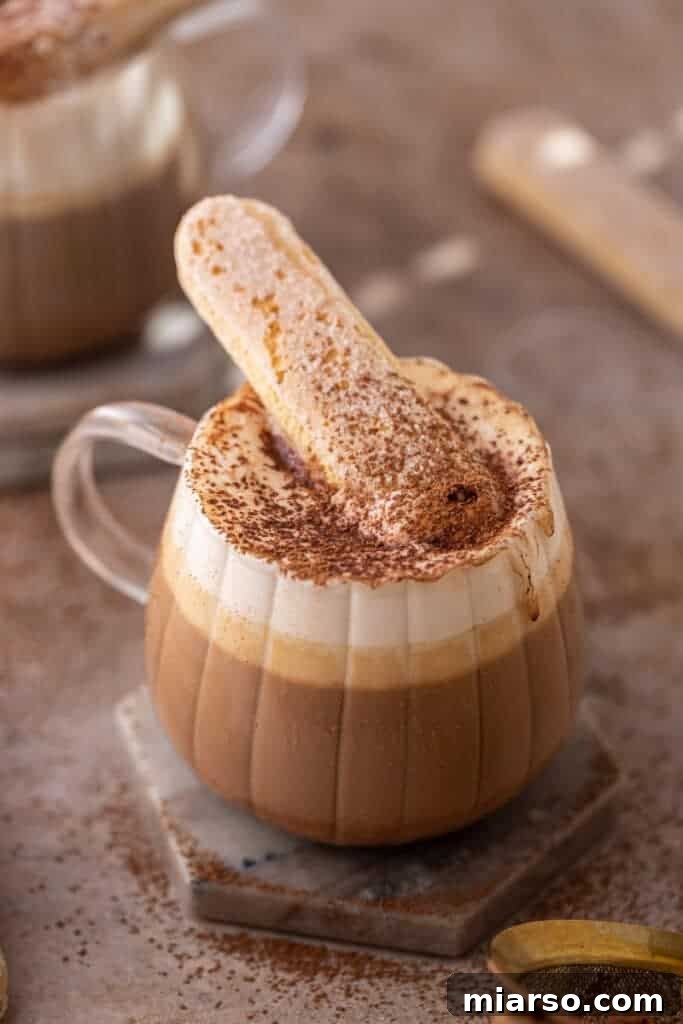 Mastering the Dreamy Tiramisu Latte Recipe 9 A perfectly made tiramisu latte with a spoon, ready to be enjoyed.