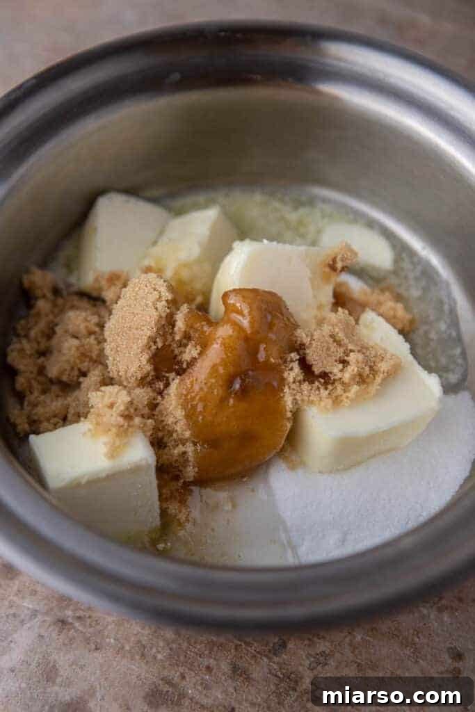 Crafting the Perfect Homemade Caramel Apple Dip 5 Ingredients for caramel sauce in a saucepan before heating, showcasing the butter, sugars, and corn syrup.