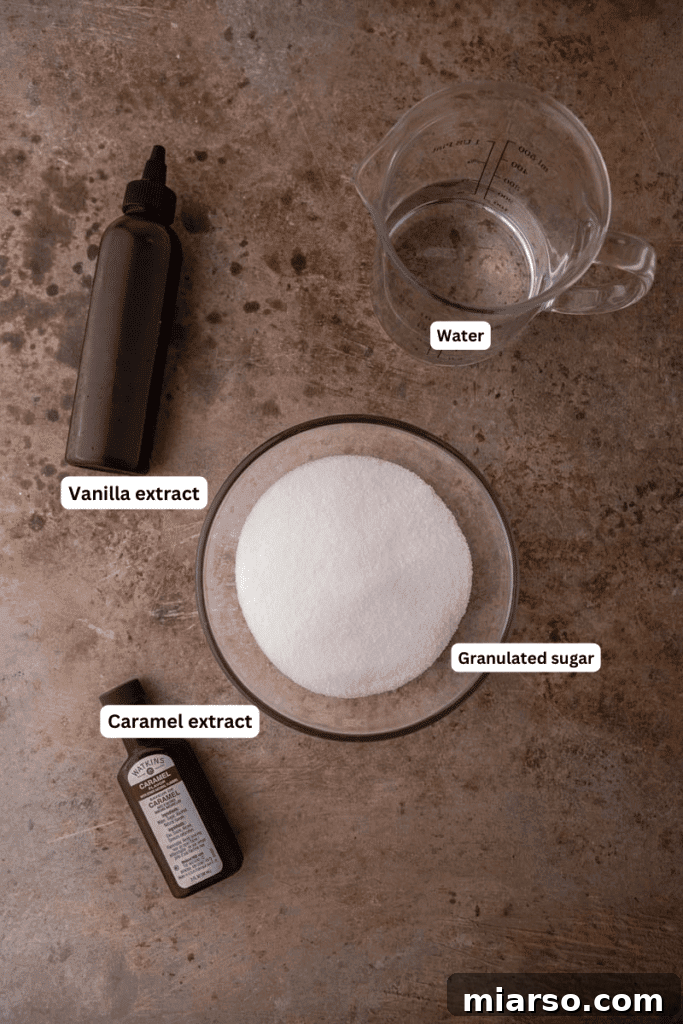 Simple ingredients for caramel syrup laid out on a kitchen counter: sugar, water, vanilla extract, and caramel extract.
